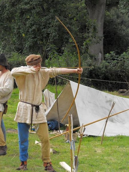 Member of The Montgomery Levy displaying archery in mediaeval times; photograph by Penny Mayes; License via Wikimedia Commons